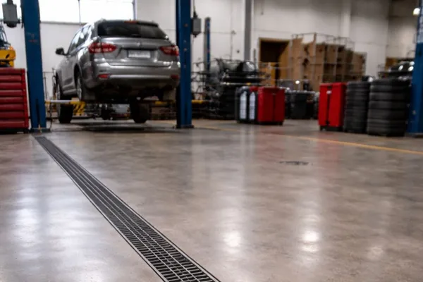 Trench drain in an automotive service bay