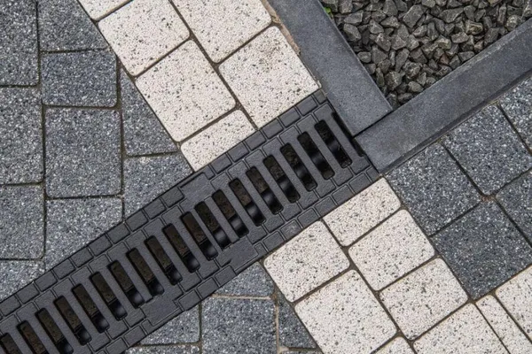 Trench drain channel set into a paver driveway